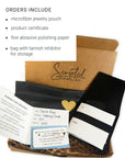 Box of Scripted Jewelry with microfiber pouch, product certificate, polishing paper, and tarnish inhibitor.