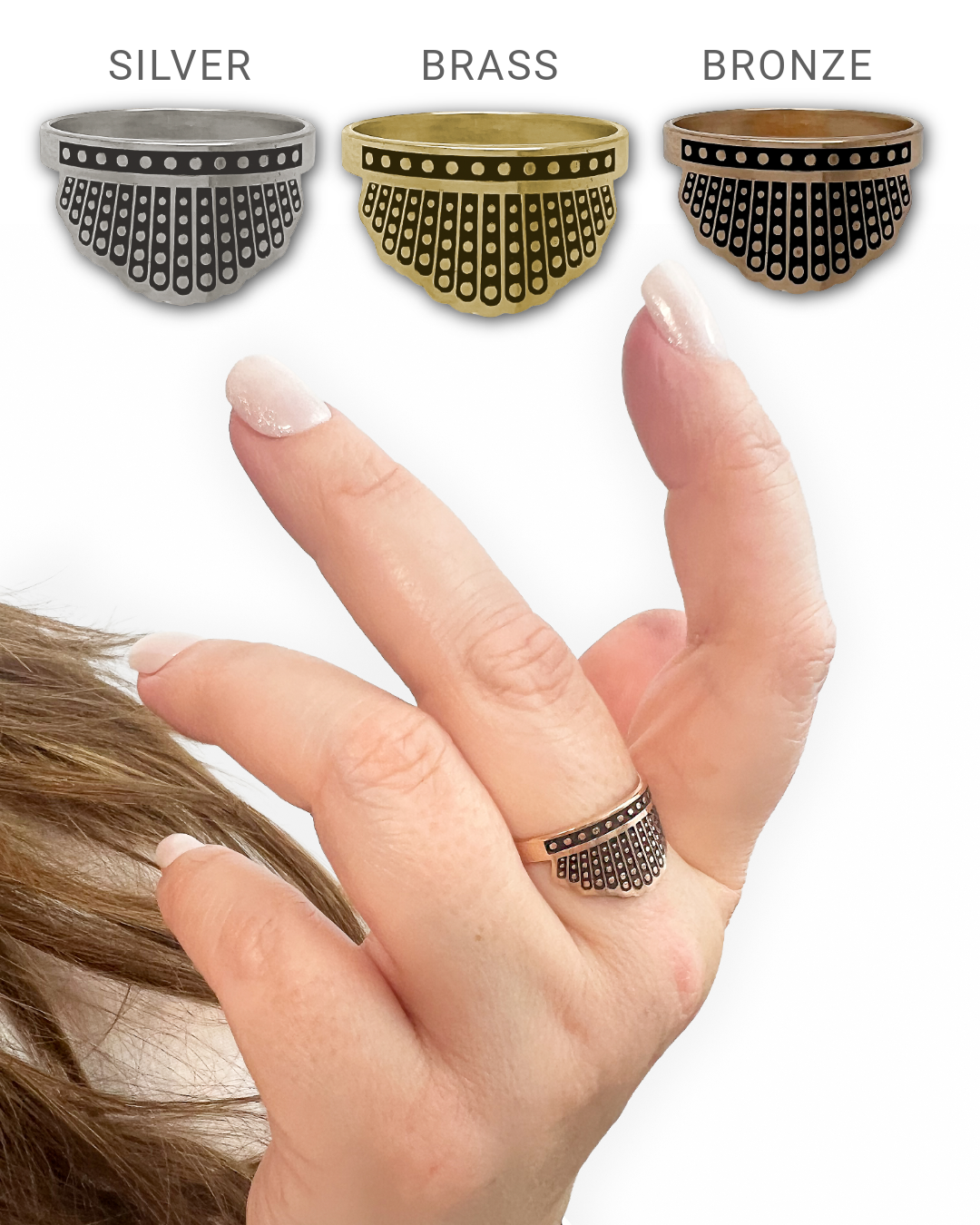 Three rings with dissent collar style in silver, brass, and bronze on a hand with a white background