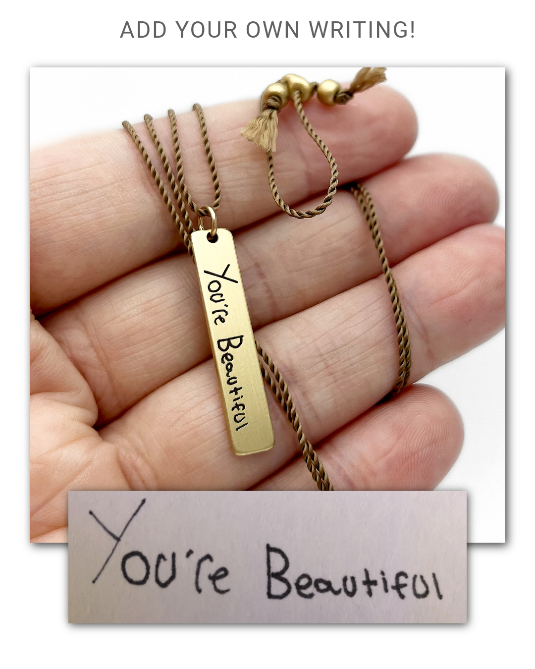 Gold necklace with 'You're Beautiful' handwriting engraved on a tag pendant held by a hand, with a small card below.