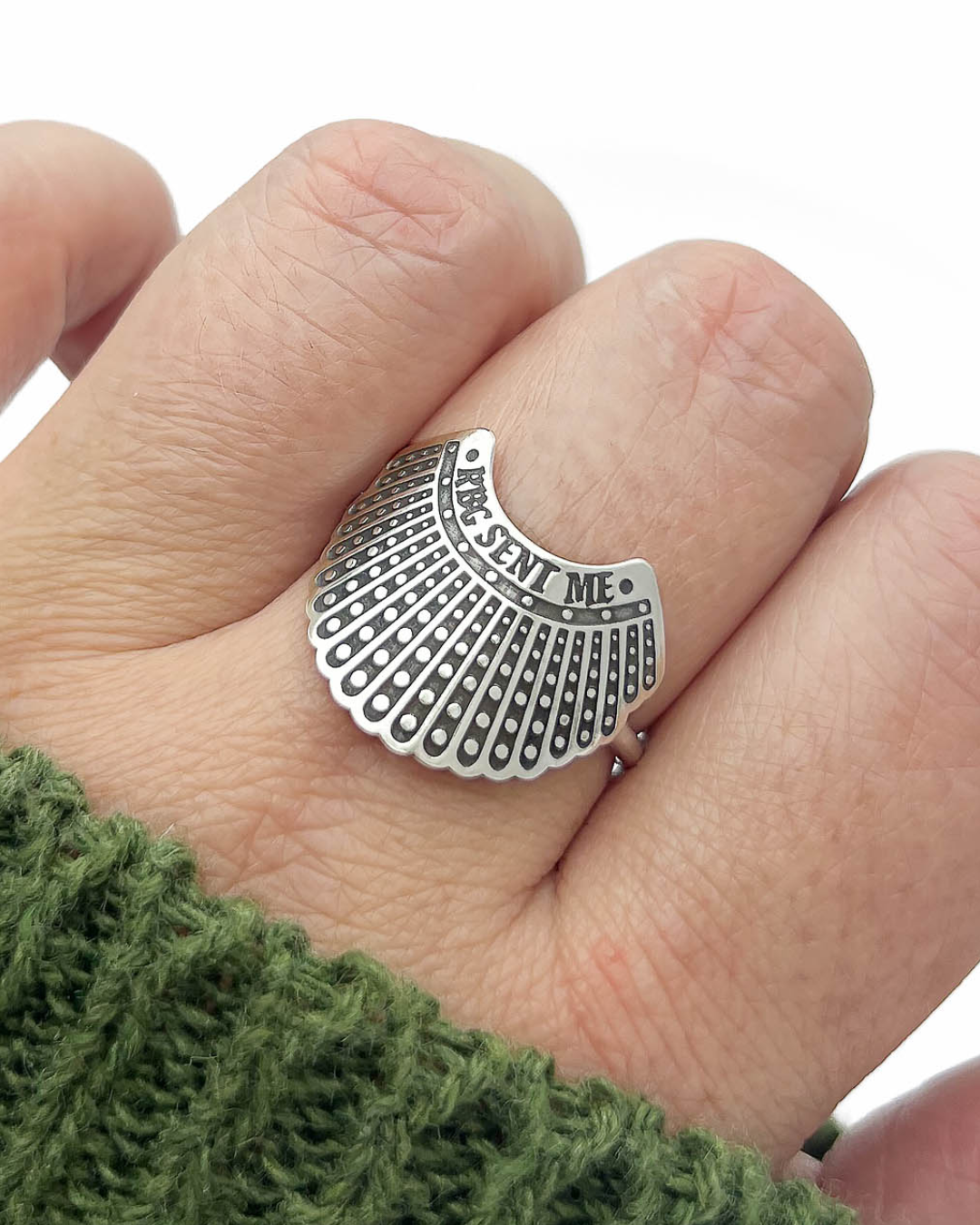 Silver dissent collar ring engraved with "RBG Sent Me".