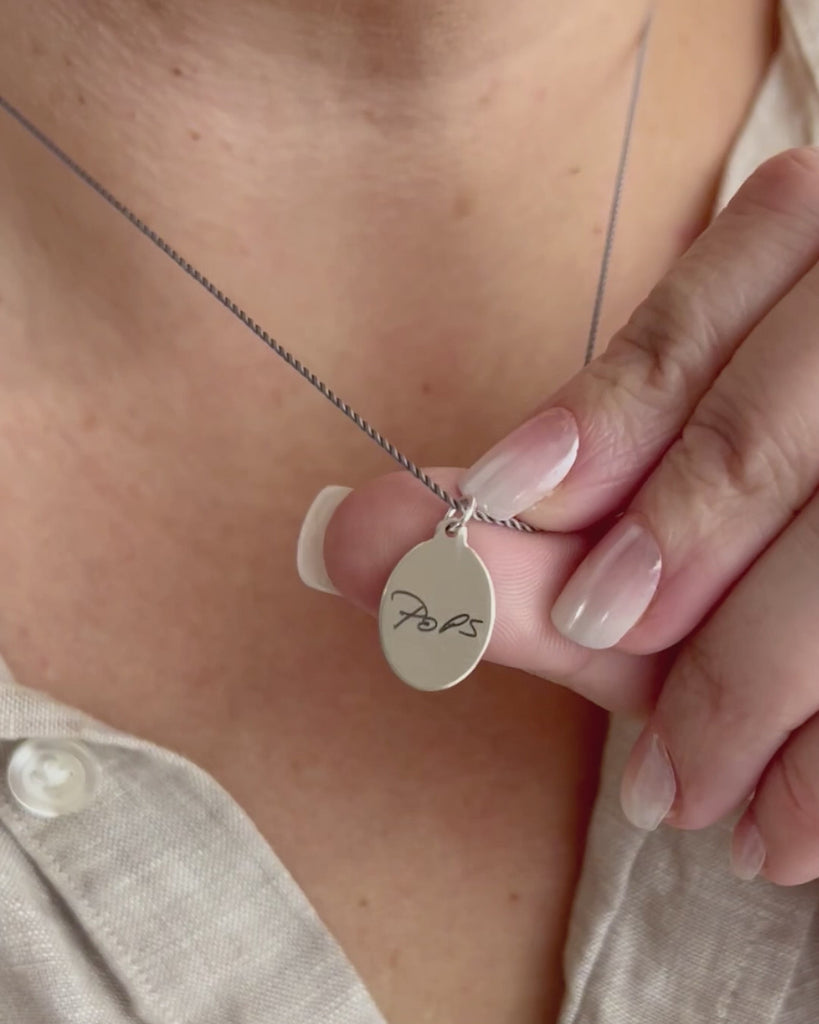 Dainty sterling oval pendant engraved with grandpa's hand writing. Modeled and moving.